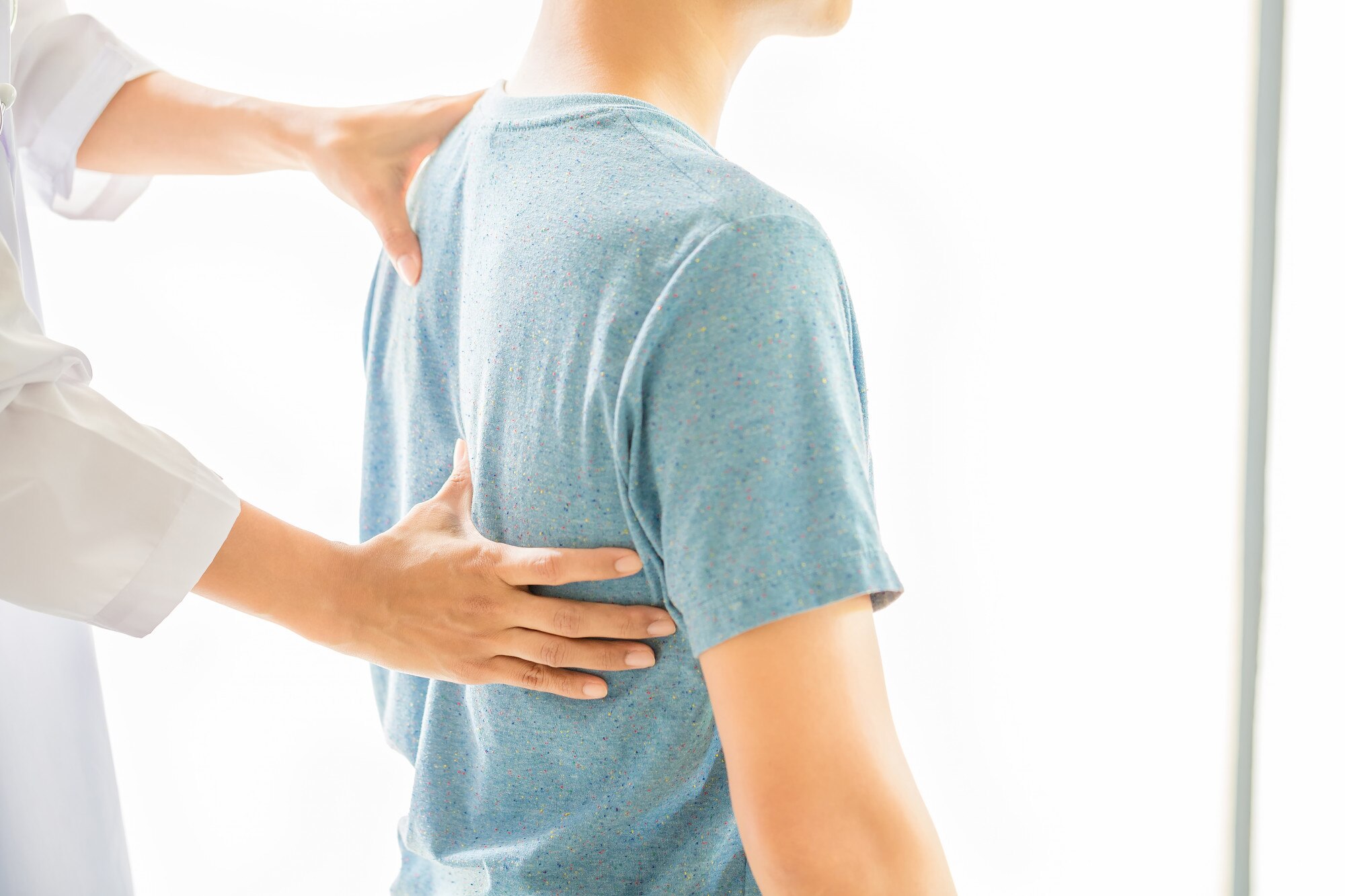 Low Back and Neck Pain close up physiotherapist working with patient clinic 1150 15062 - Low Back and Neck Pain